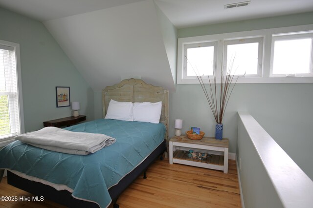105 Sandy Landing Rd, Cedar Island, NC 28520 - bedroom featuring wood finished floors and vaulted ceiling