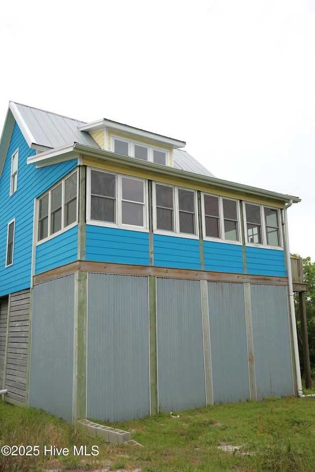 105 Sandy Landing Rd, Cedar Island, NC 28520 - view of side of property with a sunroom and metal roof