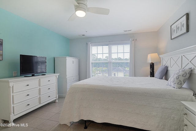 tiled bedroom with a ceiling fan