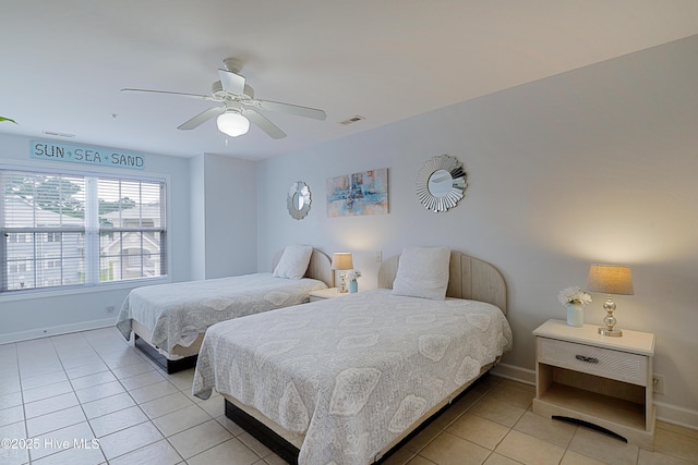 bedroom with baseboards, light tile patterned flooring, and a ceiling fan