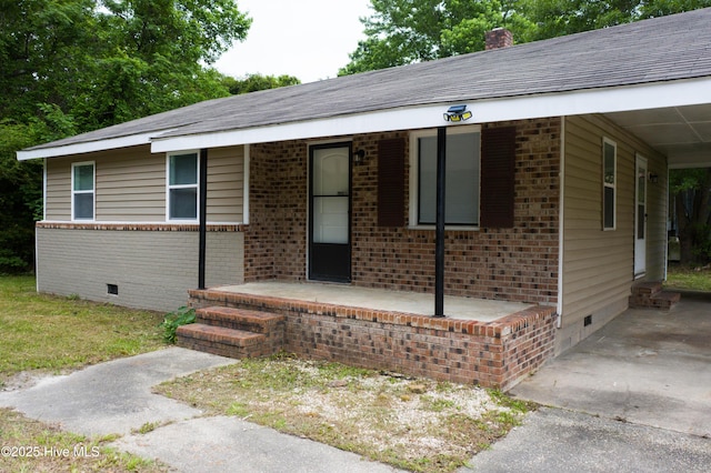 411 E Institute St, Chadbourn, NC 28431 - single story home featuring crawl space, brick siding, a chimney, and an attached carport