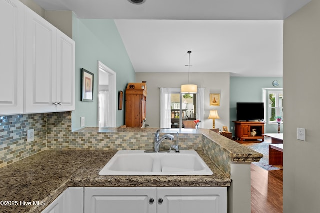 4115 Breezewood Dr Apt 202, Wilmington, NC 28412 - kitchen with a sink, plenty of natural light, open floor plan, white cabinetry, and vaulted ceiling