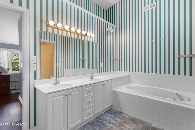 4115 Breezewood Dr Apt 202, Wilmington, NC 28412 - full bath with wallpapered walls, ensuite bath, a garden tub, and double vanity