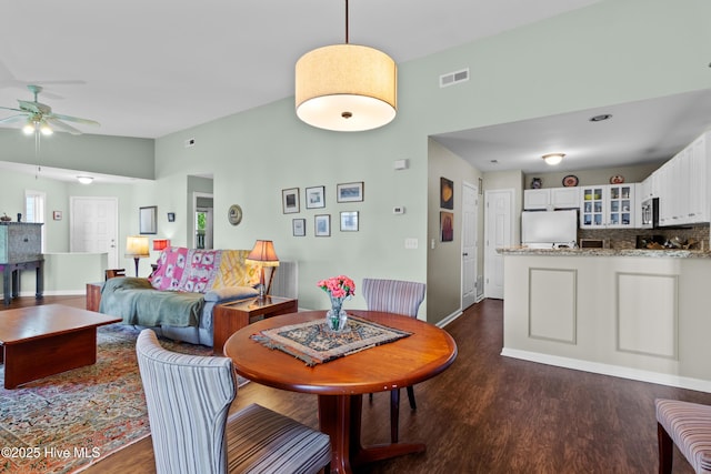 4115 Breezewood Dr Apt 202, Wilmington, NC 28412 - dining area featuring a ceiling fan, dark wood-type flooring, and baseboards