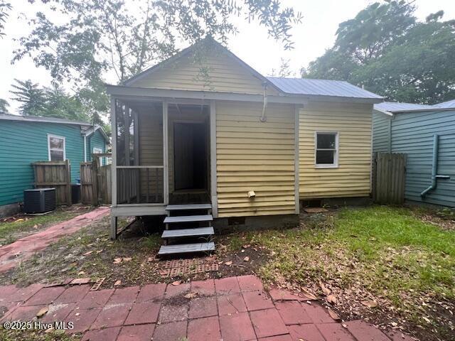 617 Fullwood St, Wilmington, NC 28401 - rear view of property with cooling unit, crawl space, fence, and metal roof