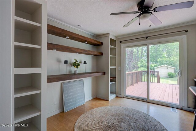 1721 Spencer Ave, New Bern, NC 28560 - unfurnished dining area with crown molding, wood finished floors, a ceiling fan, and a textured ceiling