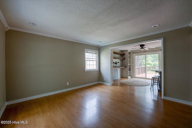 1721 Spencer Ave, New Bern, NC 28560 - spare room with crown molding, wood finished floors, baseboards, a textured ceiling, and ceiling fan
