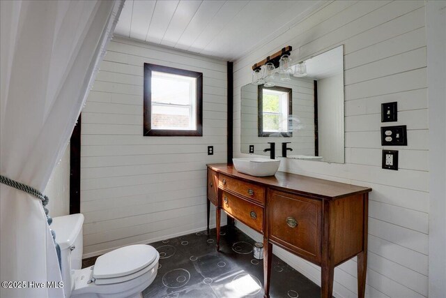 1721 Spencer Ave, New Bern, NC 28560 - bathroom with wood walls, toilet, and vanity