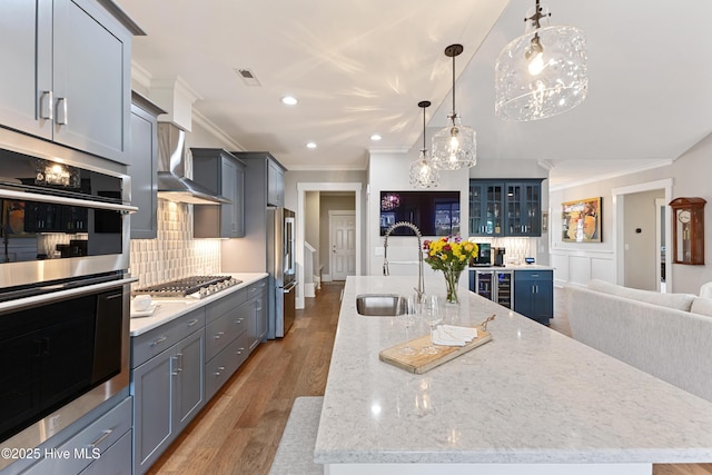 4224 Cobleskill Dr, Leland, NC 28451 - kitchen with a sink, appliances with stainless steel finishes, crown molding, a large island, and beverage cooler