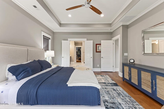 4224 Cobleskill Dr, Leland, NC 28451 - bedroom featuring a tray ceiling, ornamental molding, wood finished floors, a ceiling fan, and recessed lighting