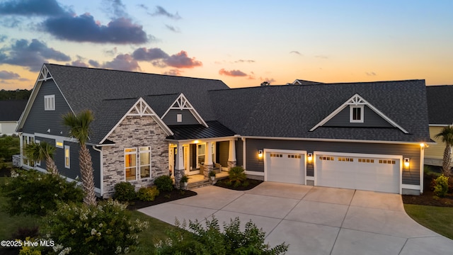 4224 Cobleskill Dr, Leland, NC 28451 - craftsman house with covered porch, concrete driveway, an attached garage, stone siding, and a shingled roof