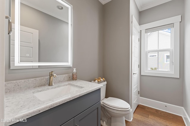 4224 Cobleskill Dr, Leland, NC 28451 - half bathroom with vanity, wood finished floors, toilet, baseboards, and crown molding
