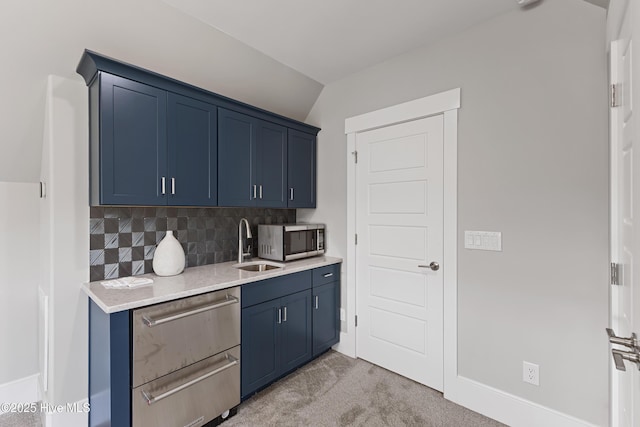 4224 Cobleskill Dr, Leland, NC 28451 - kitchen featuring stainless steel appliances, blue cabinets, light countertops, backsplash, and light colored carpet