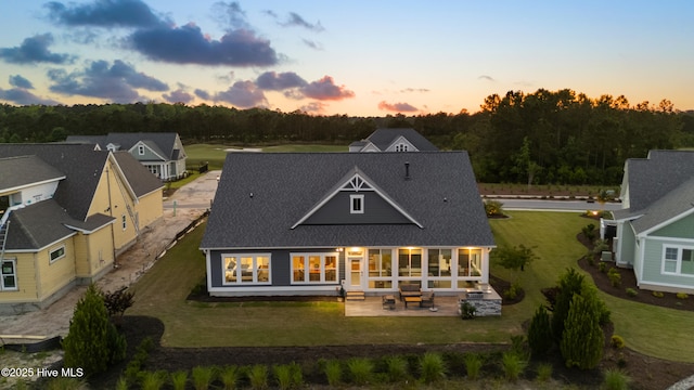 4224 Cobleskill Dr, Leland, NC 28451 - rear view of property with a patio, a yard, and a shingled roof