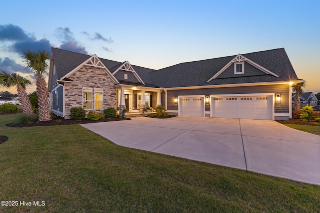 4224 Cobleskill Dr, Leland, NC 28451 - craftsman house featuring an attached garage, a yard, driveway, stone siding, and a shingled roof