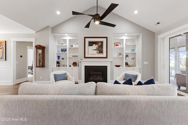 4224 Cobleskill Dr, Leland, NC 28451 - living area featuring wood finished floors, built in shelves, vaulted ceiling, a ceiling fan, and baseboards
