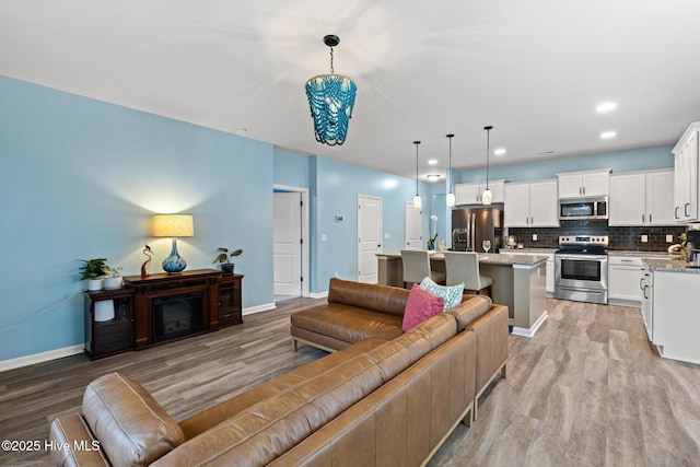 84 Capital Dr, Hampstead, NC 28443 - living room featuring light wood-type flooring, baseboards, and recessed lighting