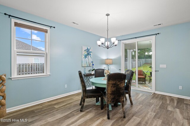 84 Capital Dr, Hampstead, NC 28443 - dining room featuring wood finished floors, a chandelier, and baseboards