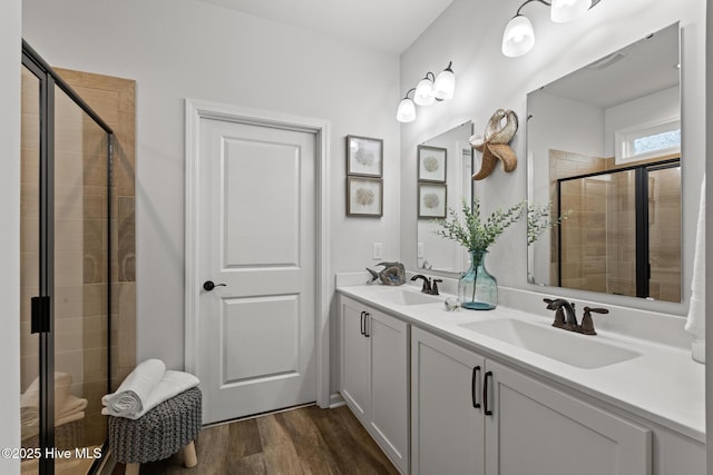 84 Capital Dr, Hampstead, NC 28443 - bathroom with a stall shower, wood finished floors, and double vanity