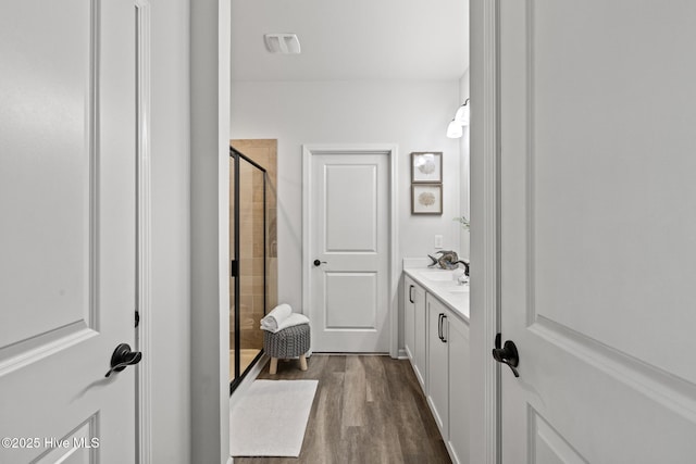 84 Capital Dr, Hampstead, NC 28443 - full bathroom with wood finished floors, vanity, and a shower stall