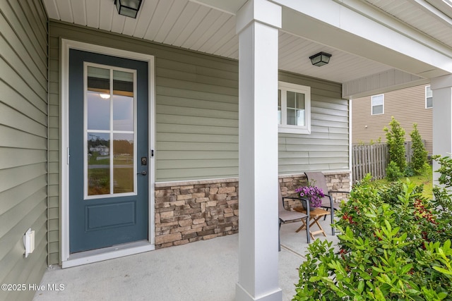 84 Capital Dr, Hampstead, NC 28443 - property entrance featuring a porch and stone siding