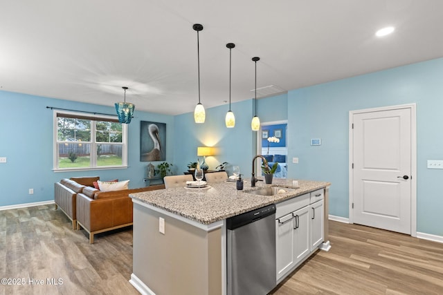 84 Capital Dr, Hampstead, NC 28443 - kitchen with a sink, dishwasher, light wood-type flooring, white cabinets, and recessed lighting