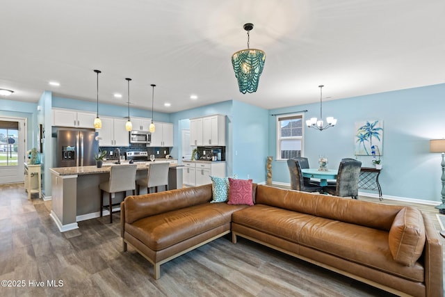 84 Capital Dr, Hampstead, NC 28443 - living room featuring a chandelier, dark wood-style floors, baseboards, and recessed lighting