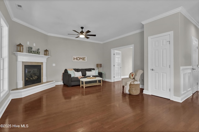1306 Wakefield Ct, Winnabow, NC 28479 - living room featuring wood finished floors, a ceiling fan, a tiled fireplace, ornamental molding, and baseboards