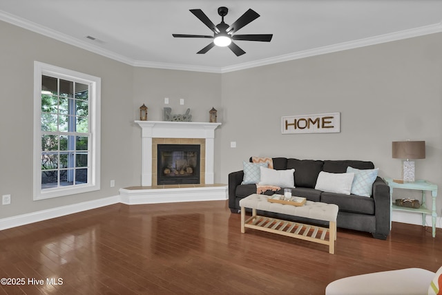 1306 Wakefield Ct, Winnabow, NC 28479 - living area featuring crown molding, wood finished floors, a tile fireplace, ceiling fan, and baseboards