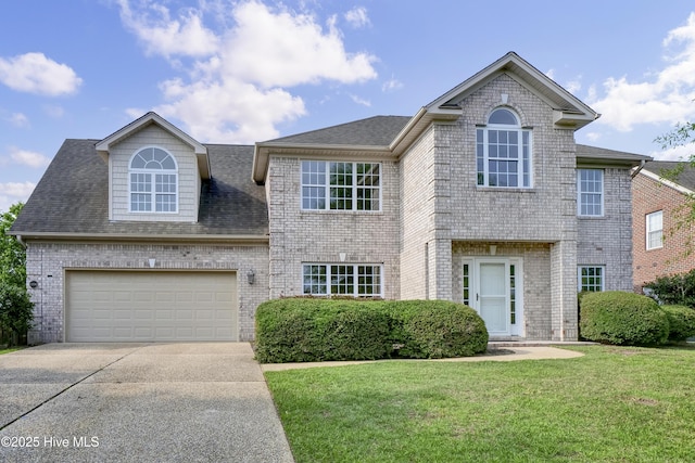 1306 Wakefield Ct, Winnabow, NC 28479 - view of front of property featuring concrete driveway, a garage, a front yard, brick siding, and a shingled roof