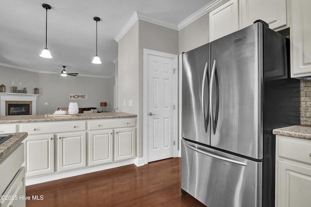 1306 Wakefield Ct, Winnabow, NC 28479 - kitchen with freestanding refrigerator, a ceiling fan, ornamental molding, dark wood-style flooring, and hanging light fixtures