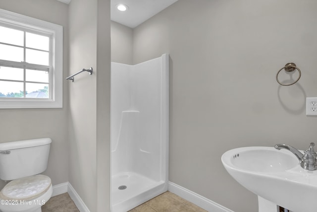 1306 Wakefield Ct, Winnabow, NC 28479 - full bath featuring a sink, a stall shower, baseboards, toilet, and tile patterned flooring