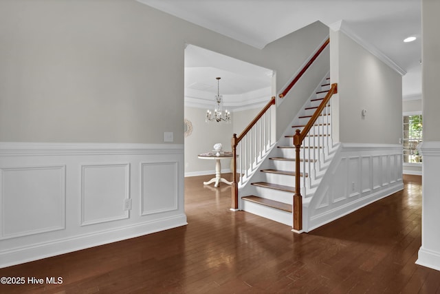 1306 Wakefield Ct, Winnabow, NC 28479 - staircase with wood-type flooring, ornamental molding, a chandelier, wainscoting, and a decorative wall