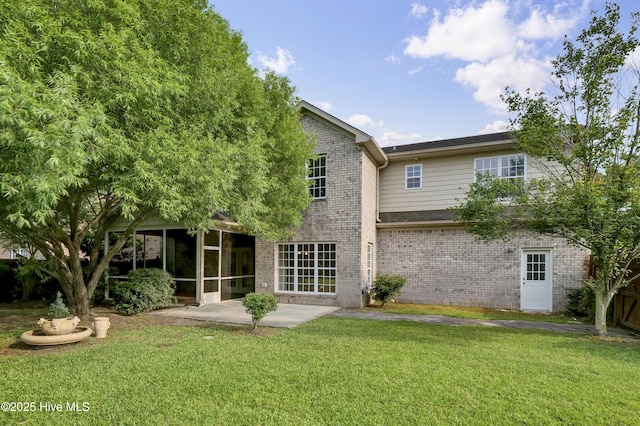 1306 Wakefield Ct, Winnabow, NC 28479 - back of property featuring a sunroom, a lawn, brick siding, and a patio
