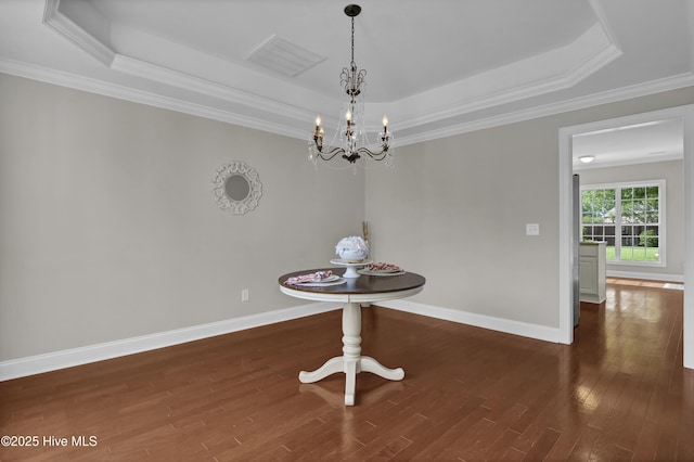 1306 Wakefield Ct, Winnabow, NC 28479 - unfurnished dining area with a raised ceiling, wood finished floors, a chandelier, and crown molding
