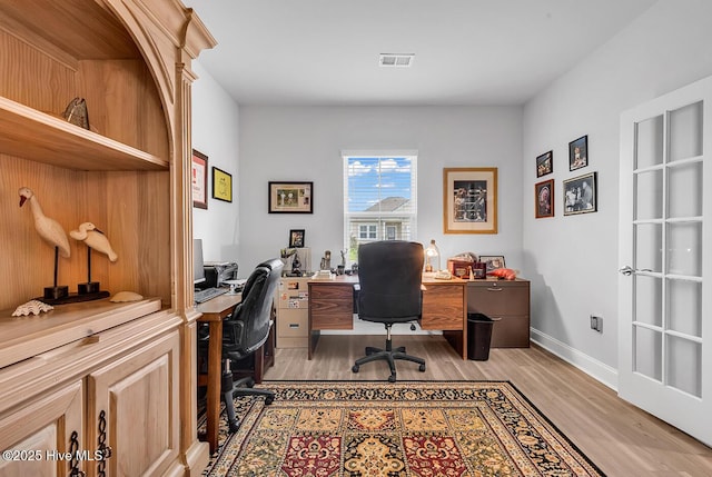 office space with light wood finished floors and baseboards