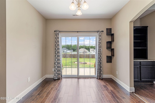 113 Kingsmill Dr, Pikeville, NC 27863 - empty room featuring dark wood-type flooring and a chandelier