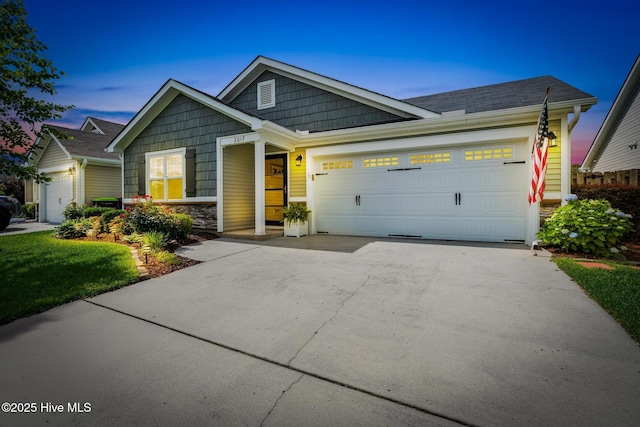 2017 Willow Stone Ct, Leland, NC 28451 - view of front of house with a garage, driveway, and stone siding