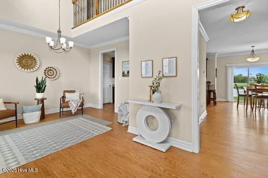 375 Summit Farms Trl, Moyock, NC 27958 - sitting room with wood finished floors, a chandelier, baseboards, and ornamental molding