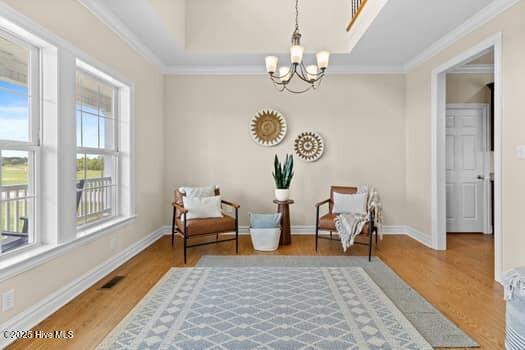 375 Summit Farms Trl, Moyock, NC 27958 - sitting room with a chandelier, wood finished floors, baseboards, and ornamental molding