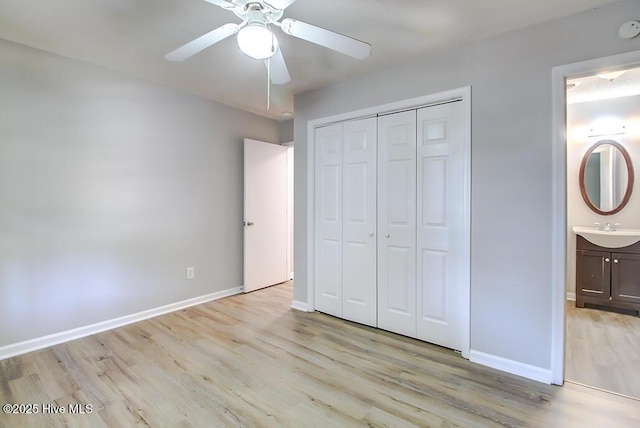 unfurnished bedroom featuring light wood-type flooring, baseboards, a closet, and ceiling fan