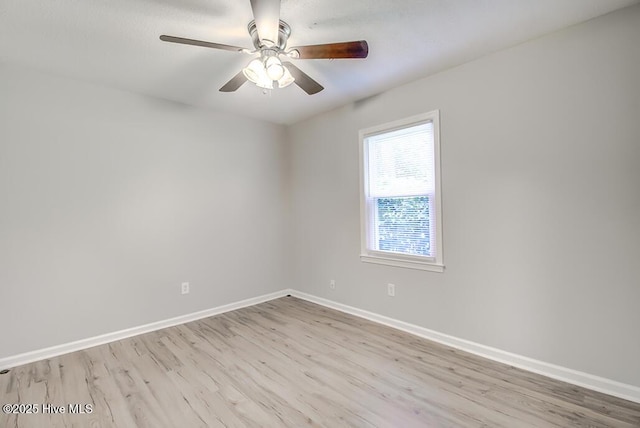 unfurnished room featuring wood finished floors, baseboards, and ceiling fan