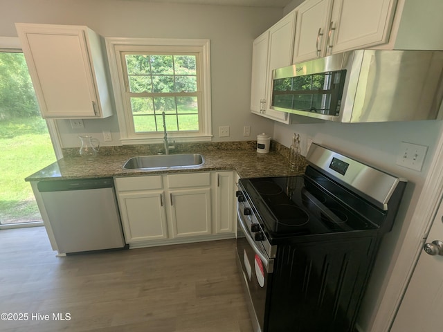 2527 Country Club Rd, Jacksonville, NC 28546 - kitchen featuring appliances with stainless steel finishes, white cabinetry, and wood finished floors