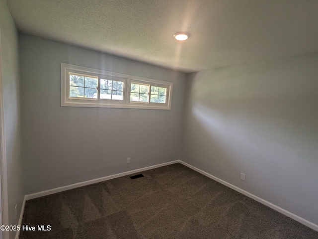 2527 Country Club Rd, Jacksonville, NC 28546 - spare room featuring dark colored carpet and a textured ceiling