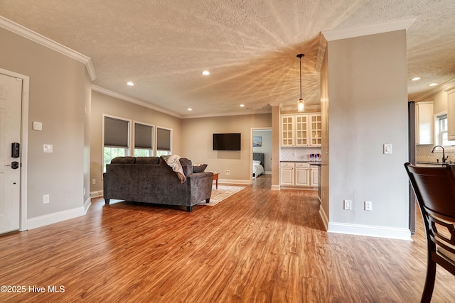 60 Pine Lake Rd, Southport, NC 28461 - living area featuring a textured ceiling, light wood-type flooring, ornamental molding, recessed lighting, and baseboards