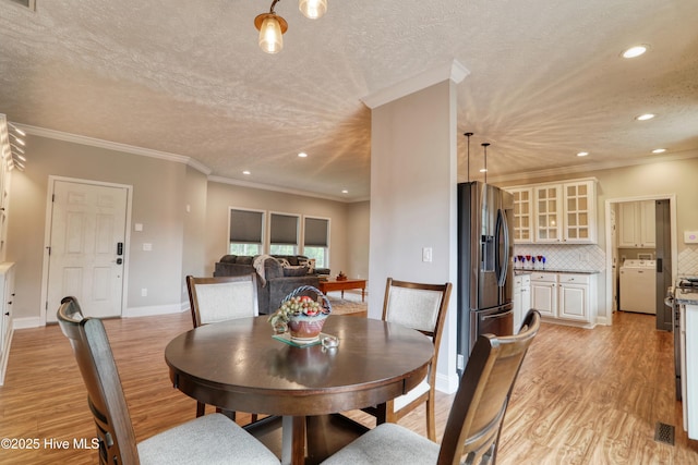 60 Pine Lake Rd, Southport, NC 28461 - dining area featuring washer / clothes dryer, light wood-type flooring, a textured ceiling, recessed lighting, and baseboards