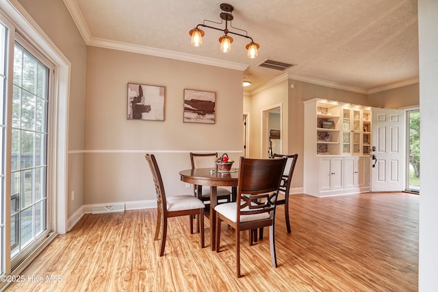 60 Pine Lake Rd, Southport, NC 28461 - dining room with light wood-style floors, baseboards, ornamental molding, and a textured ceiling