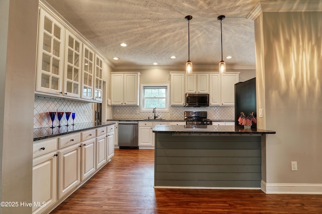 60 Pine Lake Rd, Southport, NC 28461 - kitchen featuring appliances with stainless steel finishes, a sink, ornamental molding, glass insert cabinets, and dark wood-style flooring