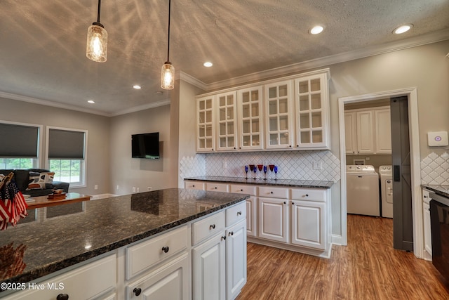 60 Pine Lake Rd, Southport, NC 28461 - kitchen featuring washer and clothes dryer, white cabinets, light wood-type flooring, backsplash, and crown molding