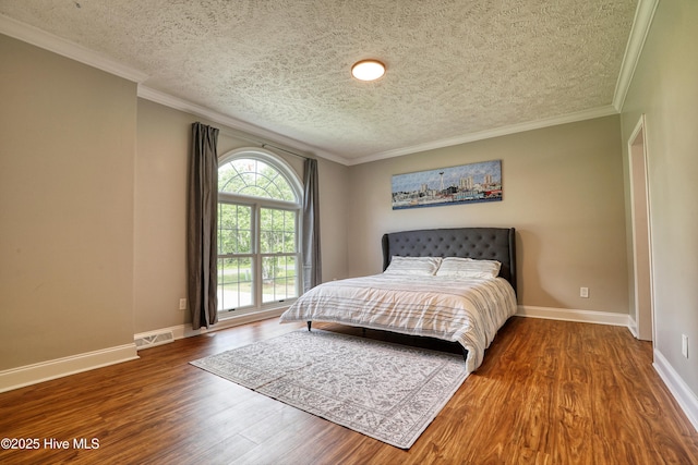 60 Pine Lake Rd, Southport, NC 28461 - bedroom featuring a textured ceiling, wood finished floors, baseboards, and ornamental molding